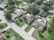 An aerial view of homes in the neighborhood featuring lush greenery and various architectural styles at 1506 Chamberlain Loop, Lake Wales, FL 33853