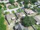 An aerial view showing neighborhood streets lined with trees and well-kept homes at 1506 Chamberlain Loop, Lake Wales, FL 33853