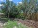 Lush backyard with healthy trees and a mulched garden at 1506 Chamberlain Loop, Lake Wales, FL 33853