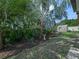 Lush backyard with healthy trees, mulched gardens, and a shed at 1506 Chamberlain Loop, Lake Wales, FL 33853