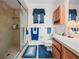 Bathroom with walk-in shower, wood cabinets, and blue-themed decor at 1506 Chamberlain Loop, Lake Wales, FL 33853