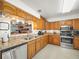 Kitchen with stainless steel appliances, oak cabinetry, and granite countertops at 1506 Chamberlain Loop, Lake Wales, FL 33853