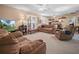Comfortable living room with plush sofas, ceiling fans, and French doors at 1506 Chamberlain Loop, Lake Wales, FL 33853