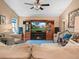 Cozy living room featuring built-in entertainment center and comfortable seating at 1506 Chamberlain Loop, Lake Wales, FL 33853