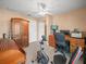 Office boasts desk, chair, computer, exercise bike, storage cabinets, and a ceiling fan at 1506 Chamberlain Loop, Lake Wales, FL 33853