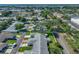 Scenic aerial view showcases the home, nestled amidst verdant trees, and the lake in the distance at 1531 Oakview Se Cir, Winter Haven, FL 33880