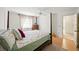 Inviting bedroom with a four-poster bed, natural light, and warm wood flooring for a cozy feel at 1531 Oakview Se Cir, Winter Haven, FL 33880