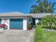 Charming home with a blue garage door, beautiful landscaping, and a well-maintained lawn at 1531 Oakview Se Cir, Winter Haven, FL 33880