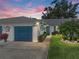 Charming home with a blue garage door, beautiful landscaping, and a well-maintained lawn at 1531 Oakview Se Cir, Winter Haven, FL 33880