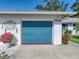 Garage door of home at 1531, with fresh paint and colorful landscaping accents at 1531 Oakview Se Cir, Winter Haven, FL 33880