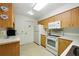 Functional kitchen with white appliances and natural wood cabinets perfect for cooking and dining at 1531 Oakview Se Cir, Winter Haven, FL 33880