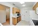 Practical kitchen showcasing ample counter space, wooden cabinets, and easy access to adjacent rooms at 1531 Oakview Se Cir, Winter Haven, FL 33880