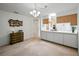 Eat-in kitchen featuring white countertops, wooden cabinets, and decorative fish artwork, full of possibilities! at 1531 Oakview Se Cir, Winter Haven, FL 33880