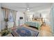 Bright main bedroom with hardwood floors, a queen bed, and cozy decor at 1531 Oakview Se Cir, Winter Haven, FL 33880