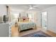Main bedroom featuring a queen bed, ceiling fan, and hardwood floors at 1531 Oakview Se Cir, Winter Haven, FL 33880