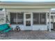 Inviting covered patio with bench seating and entrance to the home at 1531 Oakview Se Cir, Winter Haven, FL 33880