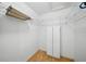 Spacious walk-in closet with white walls, wood-look vinyl flooring, and adjustable shelving and cabinets at 1531 Oakview Se Cir, Winter Haven, FL 33880