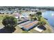 Community aerial view featuring clubhouse, pool, shuffleboard, parking, and waterfront access at 1534 Longbow Dr, Lakeland, FL 33810
