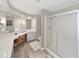 Bathroom with a shower, toilet, sink, and vanity in a neutral color palette at 1534 Longbow Dr, Lakeland, FL 33810