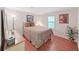Cozy bedroom with hardwood floors, comfortable bedding, and natural light through the window at 1534 Longbow Dr, Lakeland, FL 33810