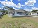 Lovely single-story home with white exterior, black shutters, covered porch, and manicured lawn at 1534 Longbow Dr, Lakeland, FL 33810