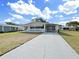 Inviting single-story home featuring a long driveway and a well-kept lawn with lush green grass at 1534 Longbow Dr, Lakeland, FL 33810