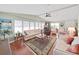 Bright and airy living room with large windows, ceiling fan, and a comfortable seating area at 1534 Longbow Dr, Lakeland, FL 33810