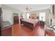 Comfortable bedroom with hardwood floors, a ceiling fan, neutral tones, and a dresser at 1534 Longbow Dr, Lakeland, FL 33810