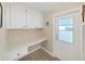 Cozy office nook with built-in desk, cabinets, and convenient outdoor access at 1534 Longbow Dr, Lakeland, FL 33810
