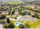 The aerial view showcases this community's green spaces, pool, tennis courts, and common areas at 1602 Eagle Pond Dr # 1602, Winter Haven, FL 33884