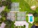 Aerial view of tennis courts, pool, parking, and clubhouse in a green community at 1602 Eagle Pond Dr # 1602, Winter Haven, FL 33884