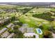 Aerial view showcases tennis courts, golf course, pool, and green spaces of this community at 1602 Eagle Pond Dr # 1602, Winter Haven, FL 33884