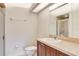 Bathroom featuring a toilet, mirror, vanity and a tiled shower at 1602 Eagle Pond Dr # 1602, Winter Haven, FL 33884