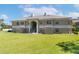 Back of the condo with green lawn and stairs to second floor units at 1602 Eagle Pond Dr # 1602, Winter Haven, FL 33884