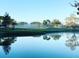 Picturesque view of a glassy pond reflecting trees and clear sky, showing the serene atmosphere at 1602 Eagle Pond Dr # 1602, Winter Haven, FL 33884