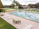 Outdoor pool with lounge chairs and tables provides a relaxing community gathering space at 1602 Eagle Pond Dr # 1602, Winter Haven, FL 33884