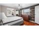 Cozy bedroom with ample natural light, featuring wood-look accent wall, dresser, and sliding door closet at 1610 Reynolds Rd # 72, Lakeland, FL 33801
