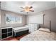 Bedroom featuring two beds, two windows, wood-look floors, and a white dresser at 1610 Reynolds Rd # 72, Lakeland, FL 33801