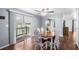 Bright dining area with a sliding glass door leading to the porch, fan, and hardwood floors at 1610 Reynolds Rd # 72, Lakeland, FL 33801
