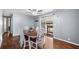 Well lit dining room featuring hardwood floors, a modern ceiling fan, and sliding door access to a porch at 1610 Reynolds Rd # 72, Lakeland, FL 33801