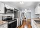 Updated kitchen boasts stainless steel appliances, white cabinetry, and hardwood floors at 1610 Reynolds Rd # 72, Lakeland, FL 33801