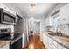Modern kitchen featuring stainless steel appliances, granite countertops and gleaming hardwood floors at 1610 Reynolds Rd # 72, Lakeland, FL 33801