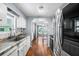 Well-lit kitchen with updated appliances, granite countertops, hardwood floors and view to a sunlit backyard at 1610 Reynolds Rd # 72, Lakeland, FL 33801
