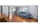 Inviting living room with plush blue sofa, and gleaming hardwood floors, brightened by natural light from sliding glass doors at 1610 Reynolds Rd # 72, Lakeland, FL 33801