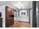 Open concept living room featuring built-in shelving, gleaming hardwood floors and sliding glass doors at 1610 Reynolds Rd # 72, Lakeland, FL 33801