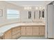 Bright bathroom featuring a skylight, double sinks, and ample counter space at 1746 Fox Hill Dr, Lakeland, FL 33810