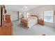 Spacious bedroom featuring a charming bed, natural light, and a mirrored closet at 1746 Fox Hill Dr, Lakeland, FL 33810