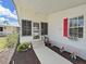 Inviting entryway with well-manicured landscaping and a charming porch, enhancing the home's curb appeal at 1746 Fox Hill Dr, Lakeland, FL 33810