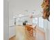 Bright kitchen with white cabinets, stainless steel appliances, and dining area with wood furniture at 1746 Fox Hill Dr, Lakeland, FL 33810
