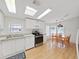 Sunlit kitchen showcasing white cabinetry, stainless steel appliances, and hardwood floors at 1746 Fox Hill Dr, Lakeland, FL 33810